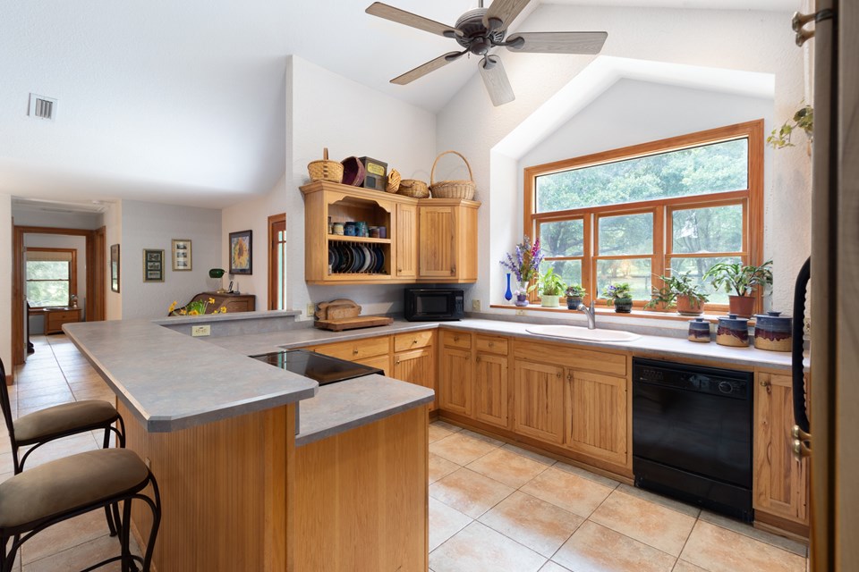 wood cabinetry with an eat-at bar