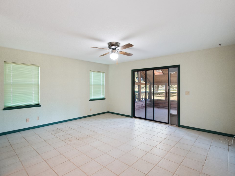 master bedroom accommodates a king bed, has his and hers closets and access to the enclosed porch