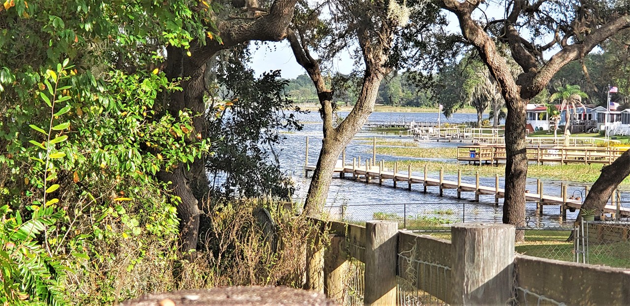 neighboring property's improved lakefront with dock