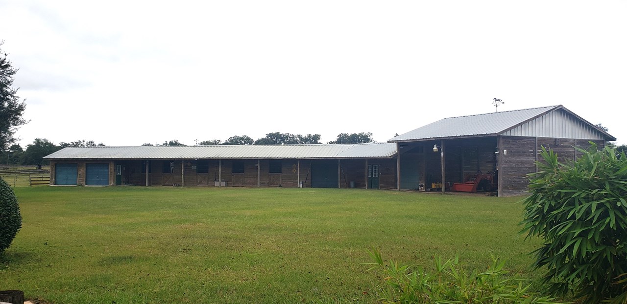 5-stall barn with 2-bay workshop and 2-bay trailer/equipment storage