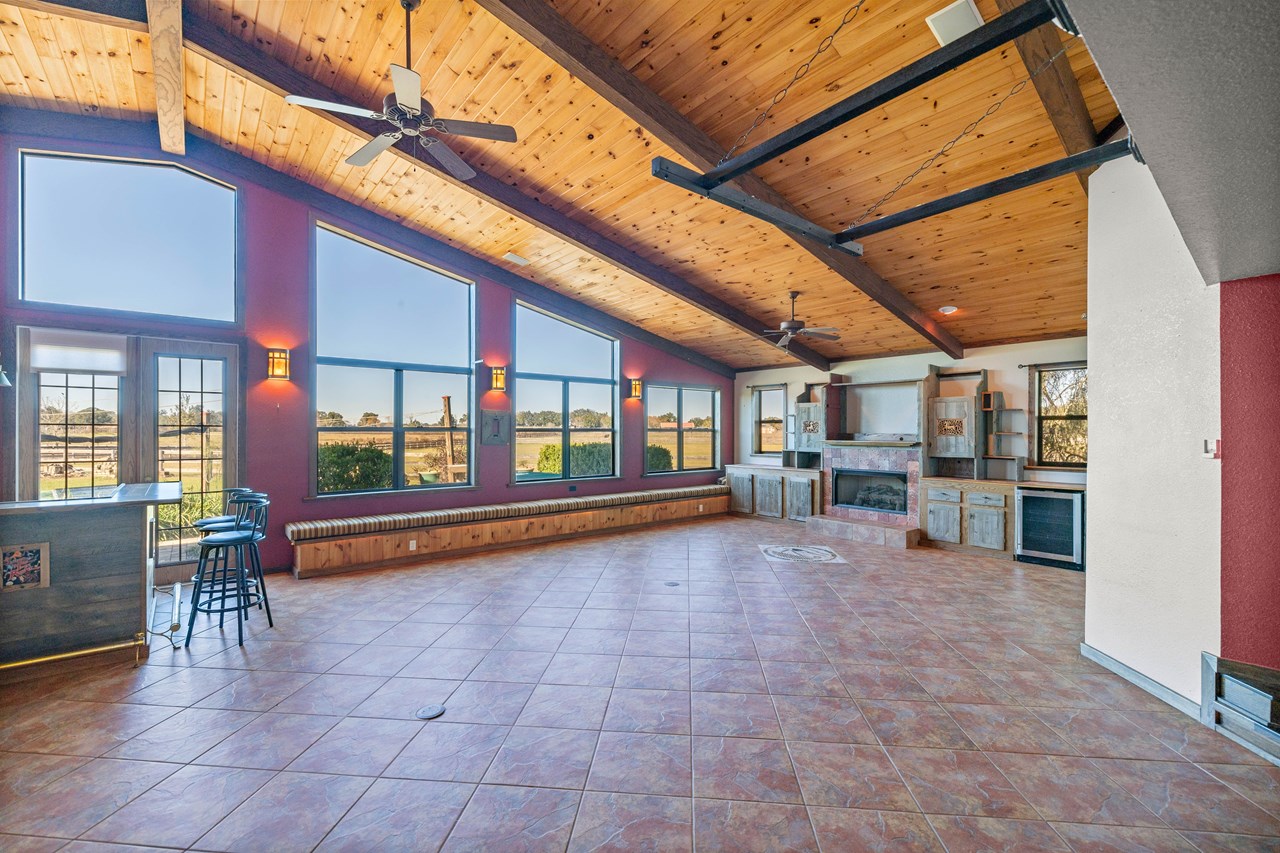 extra large family room features knotty pine ceilings, fireplace, bar and a spectacular view
