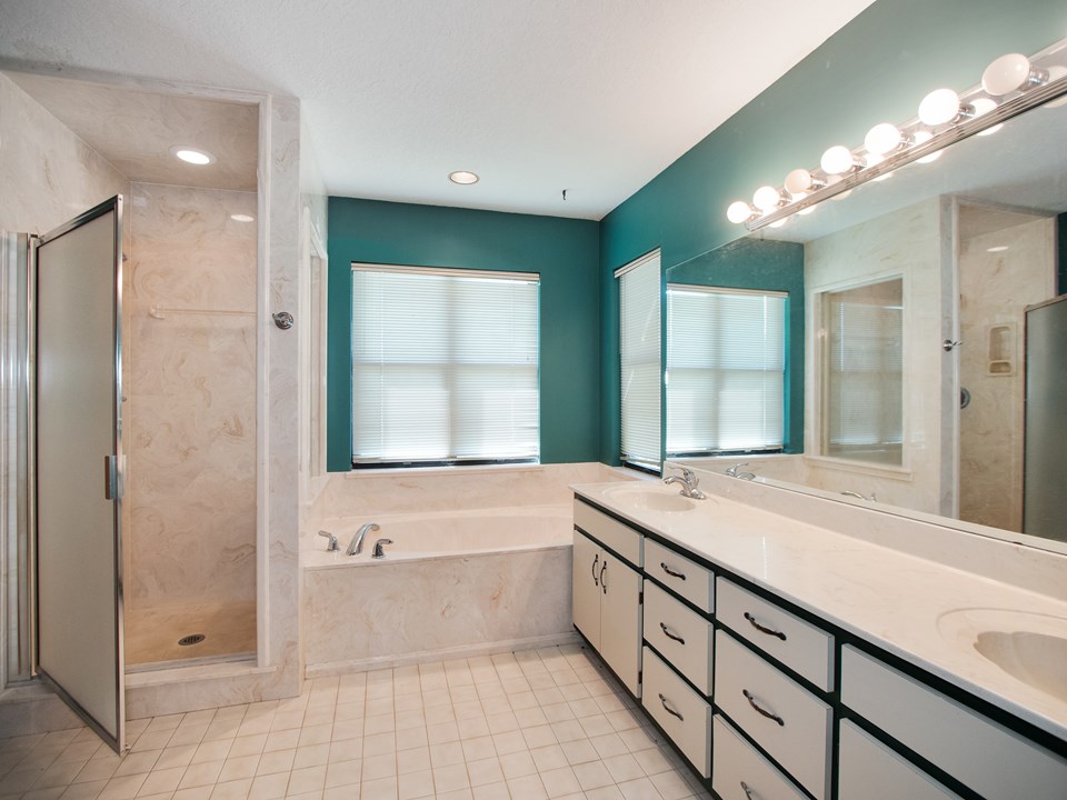 master bath features dual vanities, garden tub, walk-in shower and a private water closet