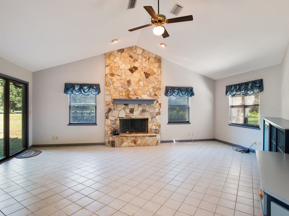 spacious family room with wood burning, stone fireplace. can you see the horse in the fireplace stones?