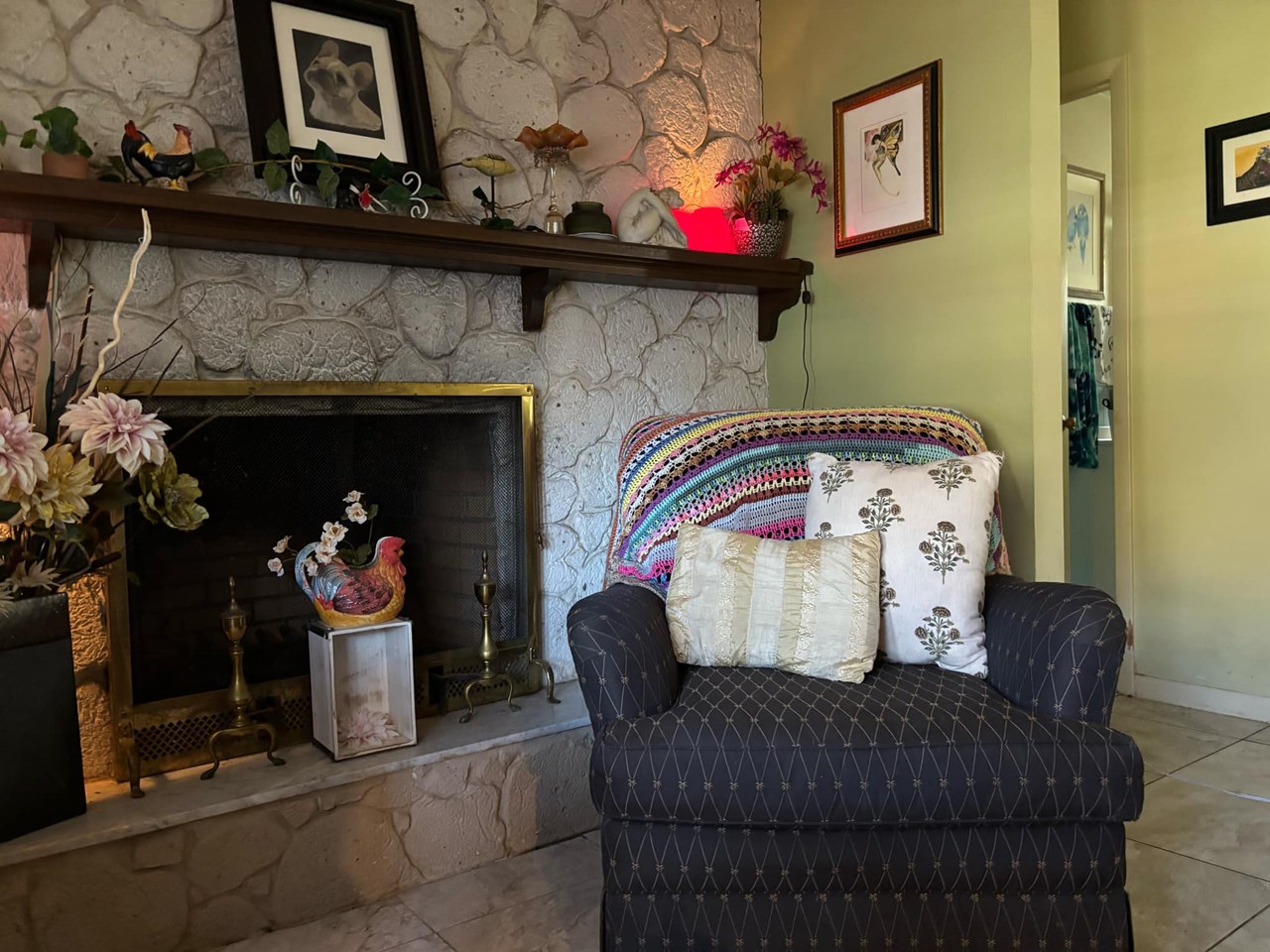 living room fireplace this cozy living room features a wood burning, stone fireplace that spans an entire wall.